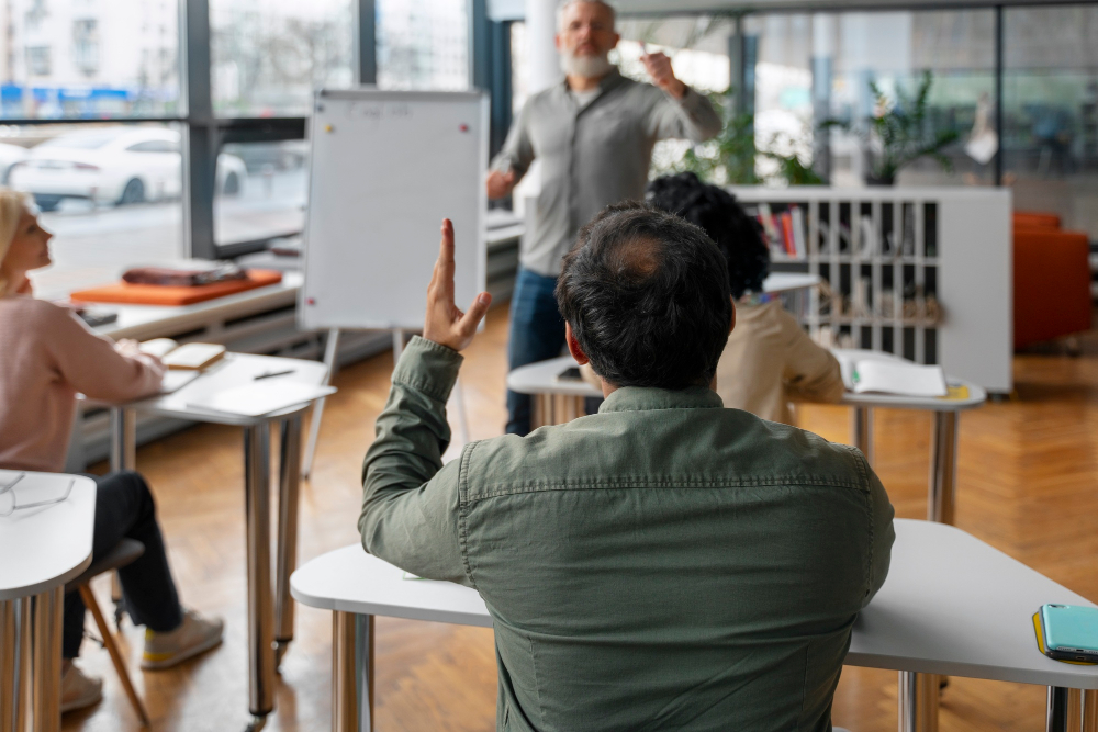 employee asking a question during a classroom-style training session