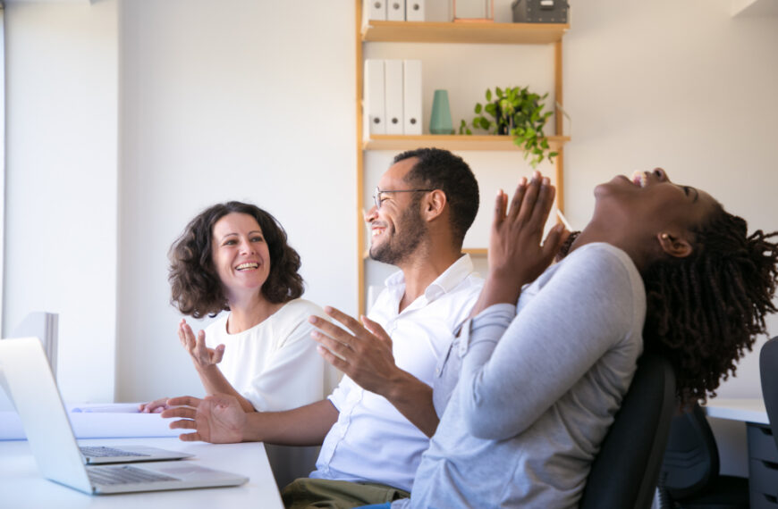 Team celebrating success together, demonstrating healthy workplace practices in action